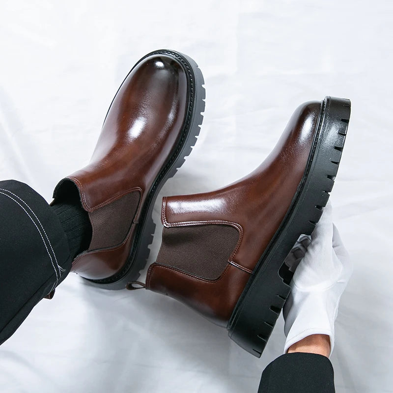 Brown MALEVA Chelsea leather boots with elastic side panels and rounded toes, displayed on a neutral background.