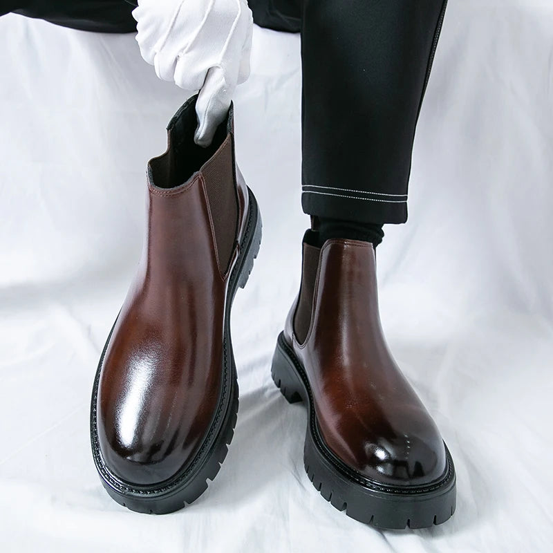 Brown MALEVA Chelsea leather boots with elastic side panels and classic ankle-length design, shown on a neutral background.